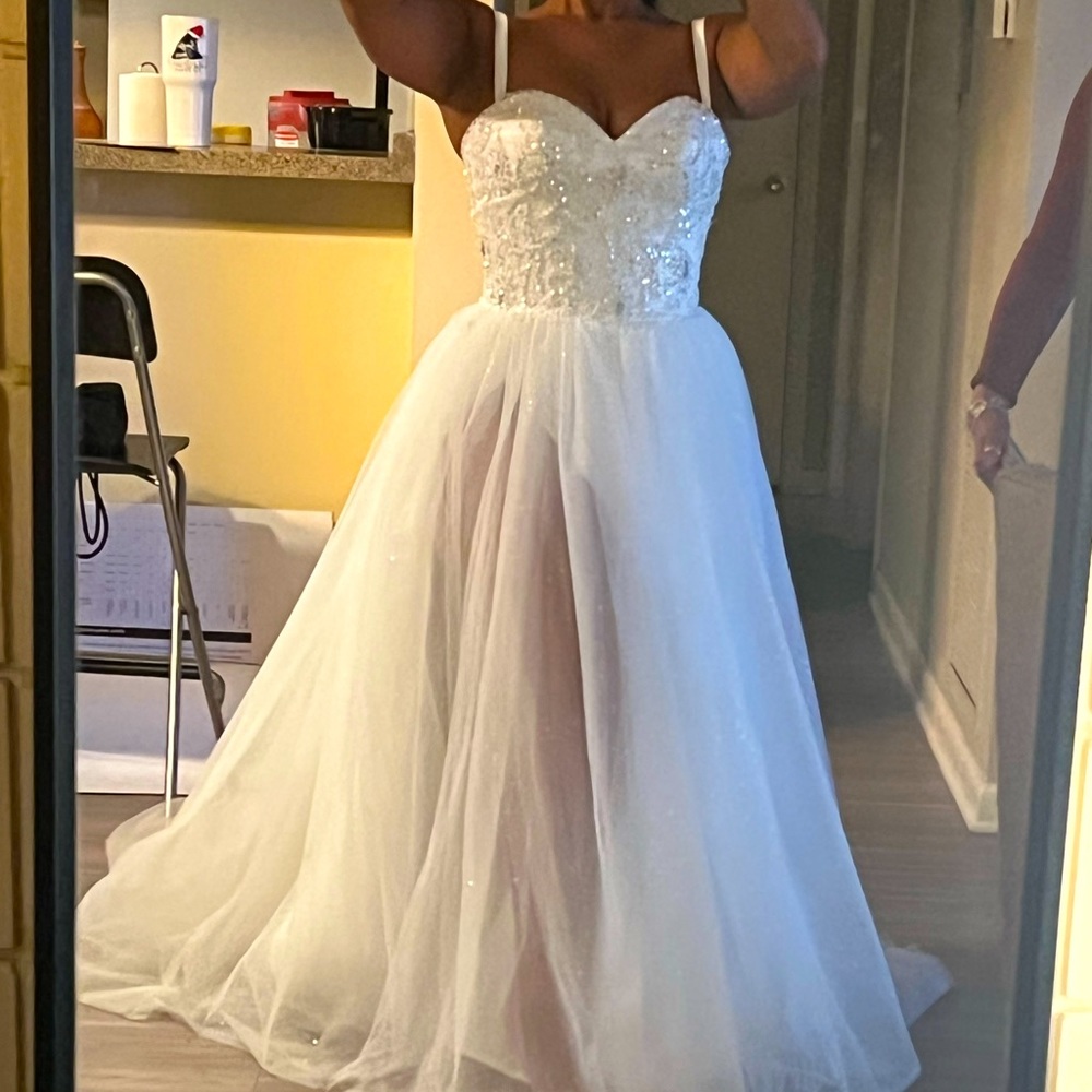 All white wedding dress with beautiful Bedazzled top and a glitter second layer.